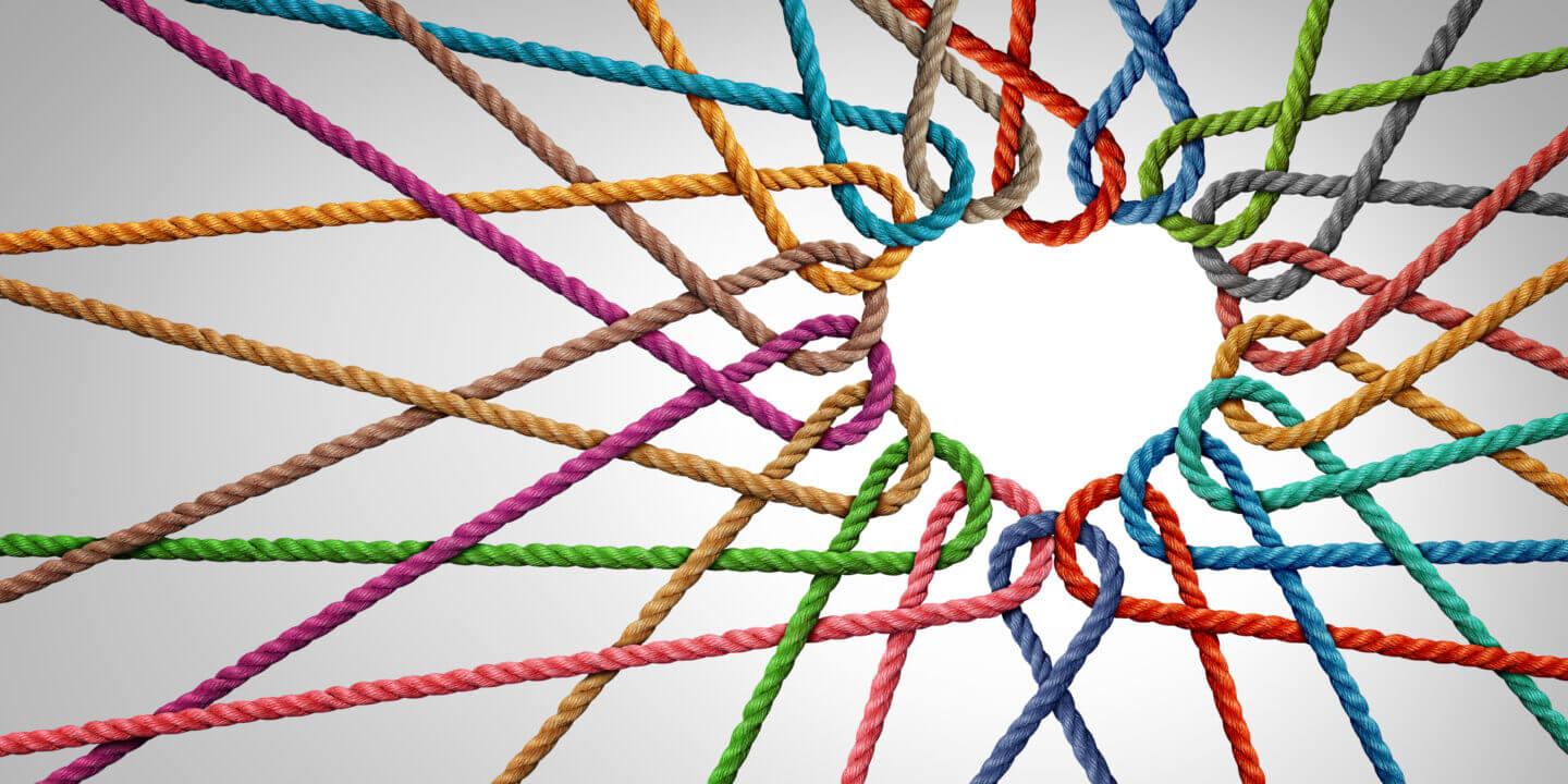multicoloured ropes woven to form heart-shape symbolising support and teamwork