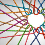 multicoloured ropes woven to form heart-shape symbolising support and teamwork